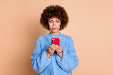 Canvas Print - Photo of smart focused serious girl dressed blue knitwear sweater look at smartphone read email isolated on pastel color background