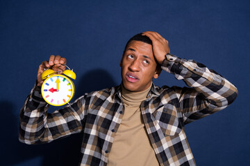 Photo of funky annoyed guy dressed plaid shirt showing clock looking emtpy space isolated blue color background