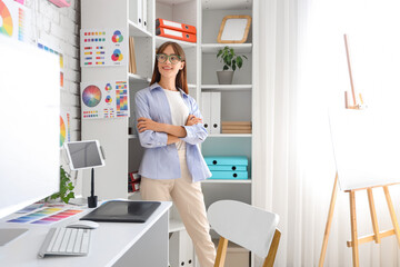 Poster - Female graphic designer near shelf unit in office