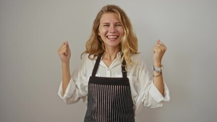 Wall Mural - Victory! young blonde woman wearing apron standing excited with raised arms and screaming proudly over white background