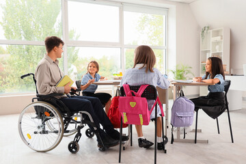 Sticker - Male teacher in wheelchair conducting lesson to little pupils at school