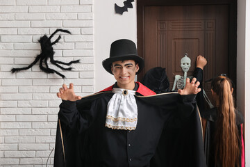 Poster - Teenage boy dressed for Halloween and his friends at door in hall