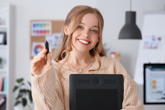 Female web designer with graphic tablet in office, closeup