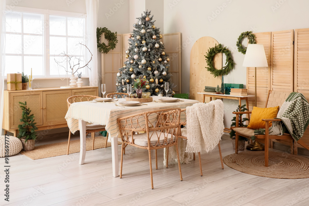 Interior of dining room with table, Christmas tree and wreaths