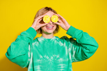 Wall Mural - Photo of shiny attractive lady dressed tie dye sweatshirt holding lemons cover eyes empty space isolated yellow color background