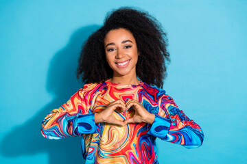 Poster - Photo portrait of beautiful curly hair woman in trendy sweatshirt showing love respect symbol isolated on blue color background