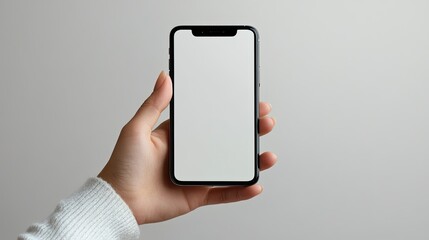 Casual person holding a smartphone with an empty background