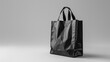 © Waraporn - Reusable eco friendly shopping bag made of durable plastic material in a simple minimalist grayscale design representing a sustainable and environmentally conscious lifestyle and consumer choices