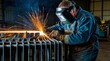© YENI - Welder working on a metal frame with protect