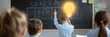 © Naru - A student raises their hand with a light bulb above their head symbolizing inspiration and creativity in a classroom setting.