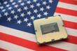 © pla2na - CPU (central processing unit) on United states of America flag. US vs China chip war or tech war, microchip semiconductor industry competition concept. US restrict and control chip export to China.