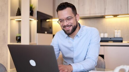 Content mid adult man conducting business online from home