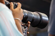 © suman - Close-up of a photographer using telephoto lens to captured a moment