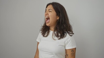 Poster - Angry young hispanic woman wearing white t-shirt standing furious, shouting with rage and frustration over isolated background