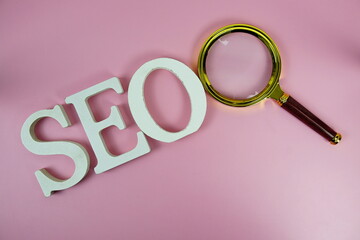 Aufkleber - Seo words (Search Engine Optimization) letters with magnifying glass on pink background