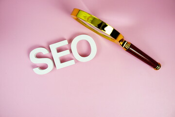 Aufkleber - Seo words (Search Engine Optimization) letters with magnifying glass on pink background