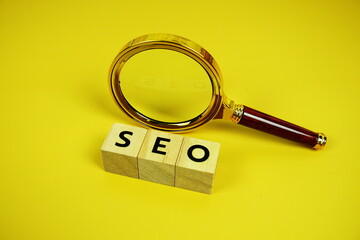 Aufkleber - Seo words (Search Engine Optimization) letters with magnifying glass and compass on yellow background
