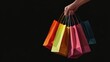 © Johannes - Illustration on a black background, a hand holds bags with purchases made on Black Friday. For advertising, banner, business transparent background