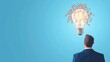 © weerasak - A businessman contemplates innovative ideas represented by a glowing light bulb surrounded by creative elements.