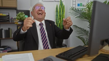 Poster - Elderly man with grey hair in a suit energetically gesturing in an office setting with plants and shelves in the background.