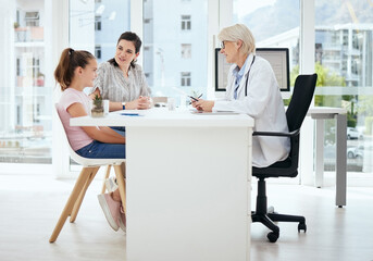 Canvas Print - Checkup, doctor and talking to child, healthcare and mature woman with question, clinic and smile. Office, mom and daughter in appointment, writing and conversation for health of kid and pediatrician