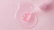 © fotofabrika - A close-up view of pink liquid being dispensed from a dropper on a smooth surface highlighting its texture and color