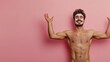 © fotofabrika - Young man applying facial mask in a playful manner against a pink background, showcasing his joy and confidence