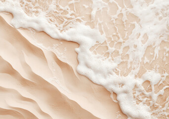 Wall Mural - Aerial view of soft sea foam washing over sand dunes background