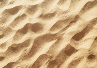 Wall Mural - Aerial view of fine sand forming gentle waves on a sunny beach