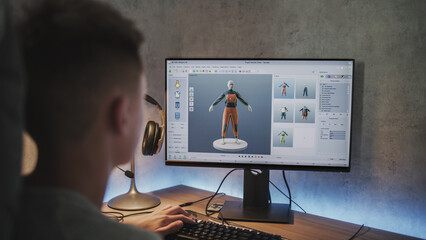 Fototapete - Young designer creates and draws clothes using PC. Interface of professional 3D modeling or design software. Teenage boy working on freelance project on computer at home. Game development concept.