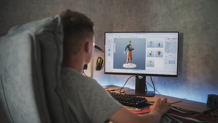 Fototapete - Young designer creates and draws clothes using PC. Interface of professional 3D modeling or design software. Teenage boy working on freelance project on computer at home. Game development concept.