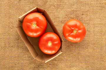 Wall Mural - Fresh ripe vegetables, red tomatoes, on jute cloth, macro, top view.