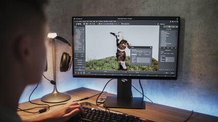 Fototapete - Young designer creates 3D model and animation of game character using computer. Interface of professional 3D modeling software. Teen boy working on freelance project on PC at home. Game development.