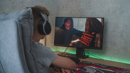 Poster - caucasian teenager in headphones watches online thriller or action film on personal computer while s