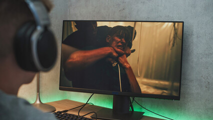 Poster - young boy wearing headphones watches online thriller movie with fight on personal computer sitting a