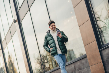 Canvas Print - Photo of cheerful young man dressed trendy clothes walking city megapolis pastime spring day outdoors