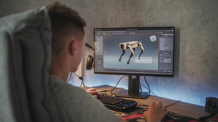 Fototapete - Young designer creates 3D model and animation of the robot dog using PC. Interface of professional 3D modeling software. Teenage boy working remotely on freelance project on computer at home.