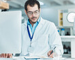 © peopleimages.com - Laboratory, computer and man with notes for research, check information and science investigation. Healthcare, notebook and male scientist with digital for medical report, diagnosis tips or treatment