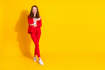 Poster - Full size photo of pretty young woman direct finger empty space wear red suit isolated on yellow color background