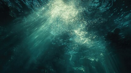 Beneath the ocean surface, light streams through the water creating a serene and mystical underwater view.