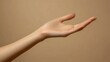 © budi - An Open Hand with Palm Facing Upward Against a Light Brown Background