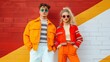 © Pojjanee - Retro Cool: A stylish young couple in vibrant 70s-inspired fashion leans against a colorful brick wall, exuding vintage charm with their bold sunglasses and confident poses.