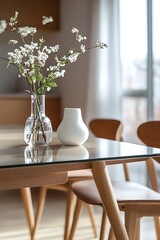 Wall Mural - A close-up of a glass vase with white flowers on a wooden table.