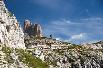 Wall Mural - Stunning view of a tourist enjoying the view of the Tre Cime Di Lavaredo, Dolomites, Italy.