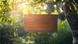 © M - Wooden blank signboard hanging on a tree in the garden, a mockup template for exterior architecture.
