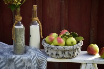 Autumn composition with apples near an old house.