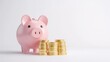 © Tackey - A pink piggy bank next to stacks of gold coins, symbolizing savings, finance, and wealth accumulation in a minimalist setting.