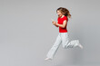 © ViDi Studio - Full body young smiling happy fun woman she wear red t-shirt casual clothes jump high hold in hand use mobile cell phone run fast isolated on plain grey background studio portrait. Lifestyle concept.