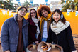 © Xavier Lorenzo - Smiling portrait of young group of student friends enjoying time together on winter. Young adult people having fun during christmas vacation outdoors.