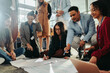 © Jacob Lund - Diverse team engaging in creative brainstorm session at seminar for new ideas